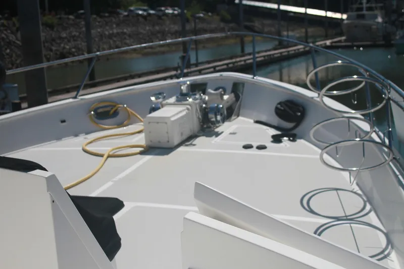 Slide: The Image of 1999 Grand Alaskan Pilothouse yacht deck with railing and equipment, docked at marina. - 101