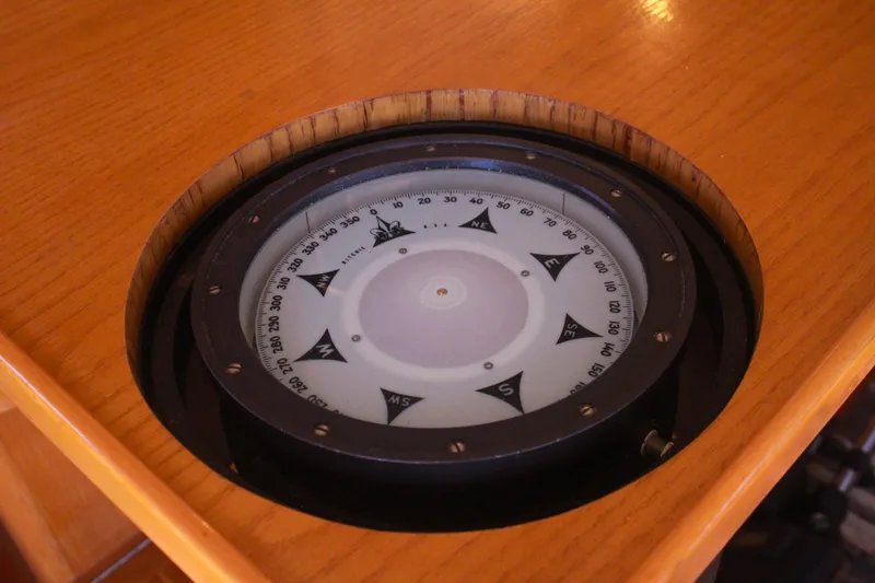Slide: The Image of Compass on 1999 Grand Alaskan Pilothouse yacht's wooden dashboard. - 109
