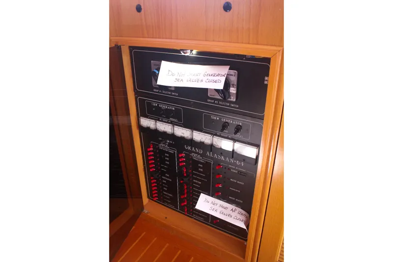 Slide: The Image of Electrical panel of a 1999 Grand Alaskan Pilothouse with caution notes on sea valves. - 111