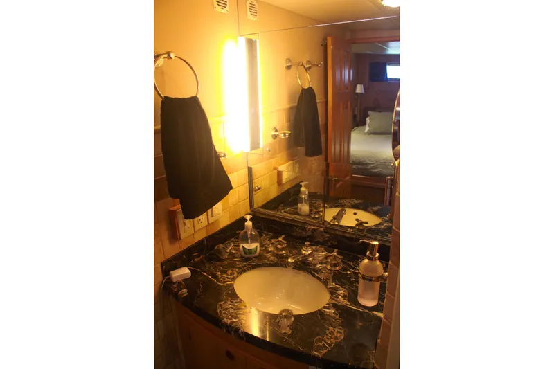 Slide: The Image of Luxurious bathroom in 1999 Grand Alaskan Pilothouse yacht with marble countertop and elegant fixtures. - 114