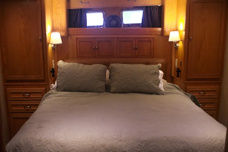 Slide: The Image of Luxurious bedroom interior of 1999 Grand Alaskan Pilothouse yacht with elegant wood cabinetry. - 115