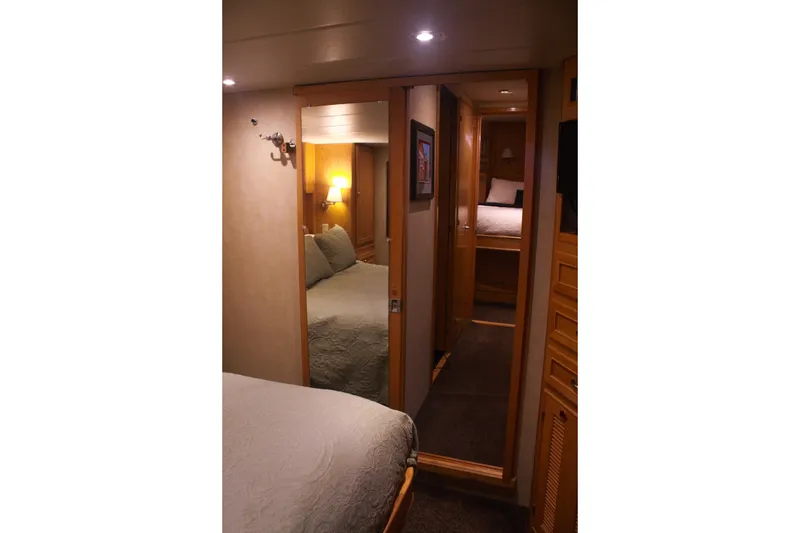 Slide: The Image of Interior of 1999 Grand Alaskan Pilothouse yacht, featuring cozy bedroom and hallway. - 118