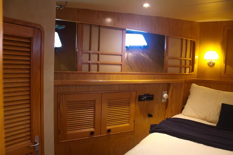 Slide: The Image of Cozy cabin interior of 1999 Grand Alaskan Pilothouse with wooden paneling and soft lighting. - 122