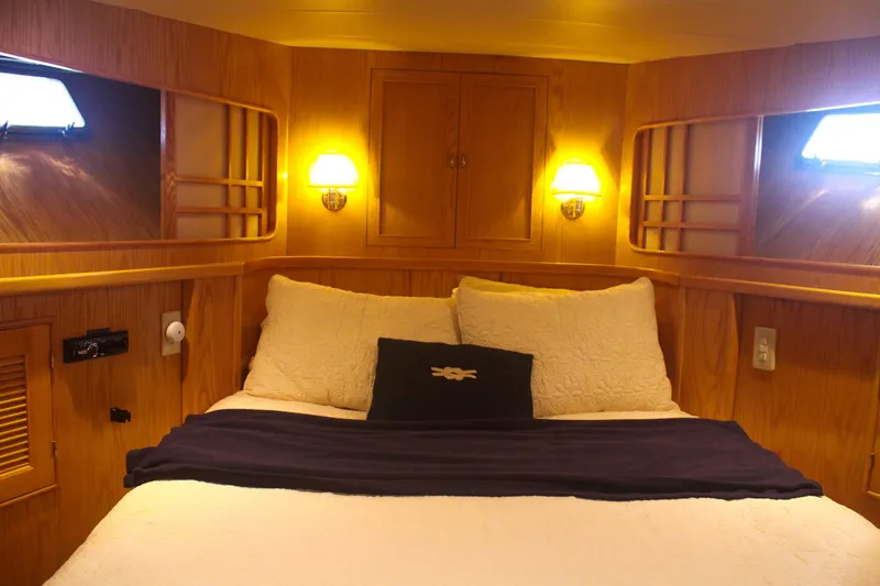 Slide: The Image of Luxurious 1999 Grand Alaskan Pilothouse cabin with cozy bed and warm lighting. - 123