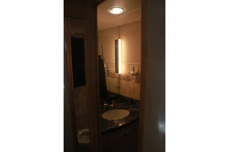 Slide: The Image of Bathroom interior of 1999 Grand Alaskan Pilothouse yacht with sink and mirror. - 125