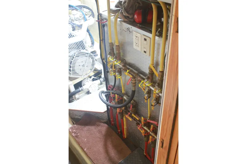 Slide: The Image of Engine room of 1999 Grand Alaskan Pilothouse with pipes and control panel. - 127