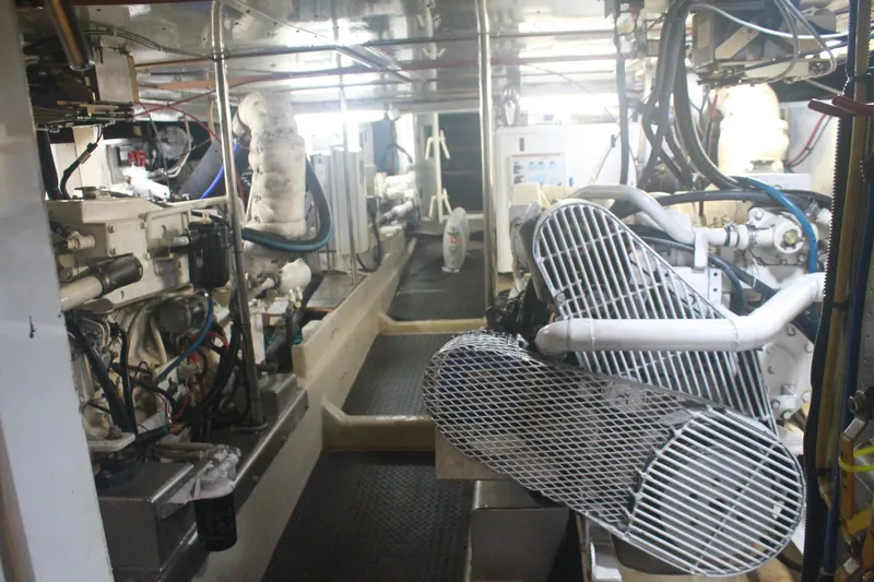 Slide: The Image of Engine room of a 1999 Grand Alaskan Pilothouse yacht, showcasing machinery and equipment. - 128