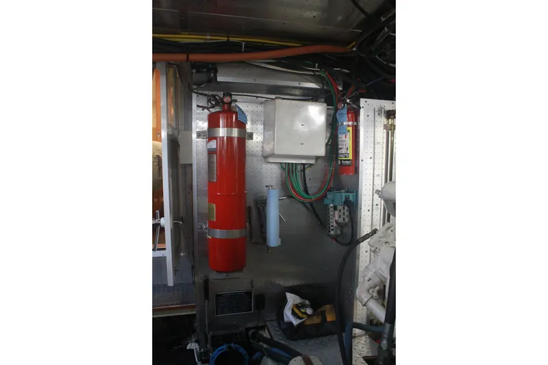 Slide: The Image of Engine room of 1999 Grand Alaskan Pilothouse with fire extinguisher and electrical components. - 131