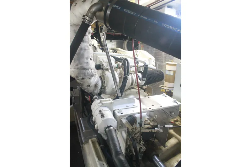 Slide: The Image of Engine room of a 1999 Grand Alaskan Pilothouse yacht, showcasing mechanical components. - 134