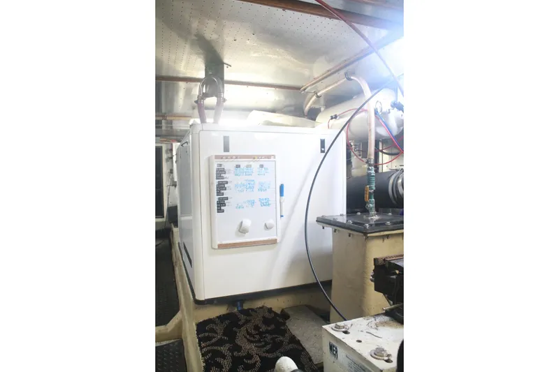 Slide: The Image of Engine room of 1999 Grand Alaskan Pilothouse yacht with machinery and equipment. - 135