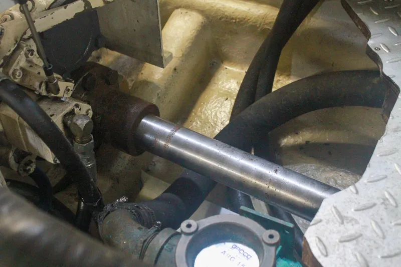 Slide: The Image of Engine room of 1999 Grand Alaskan Pilothouse, showing mechanical components and hoses. - 140