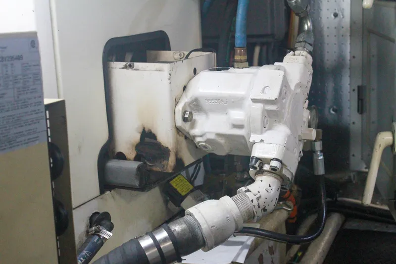 Slide: The Image of Engine room of 1999 Grand Alaskan Pilothouse with mechanical components and hoses. - 141