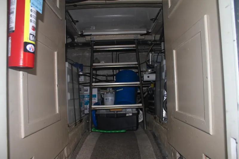 Slide: The Image of Engine room of 1999 Grand Alaskan Pilothouse with equipment and storage. - 142