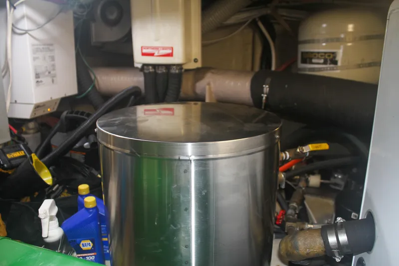 Slide: The Image of Engine room of 1999 Grand Alaskan Pilothouse with equipment and maintenance supplies. - 144