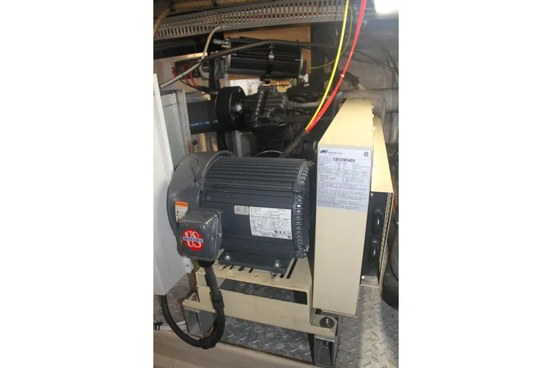 Slide: The Image of Engine room of 1999 Grand Alaskan Pilothouse yacht with machinery and wiring. - 146