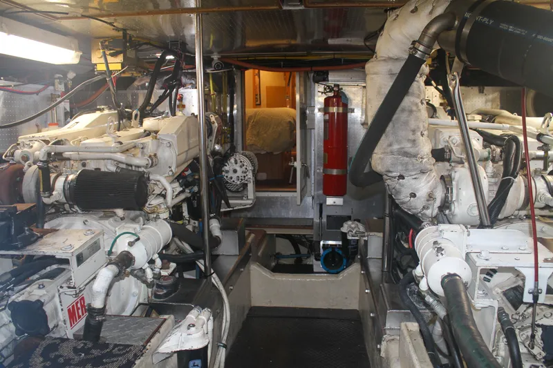 Slide: The Image of Engine room of a 1999 Grand Alaskan Pilothouse yacht, featuring dual engines and equipment. - 149