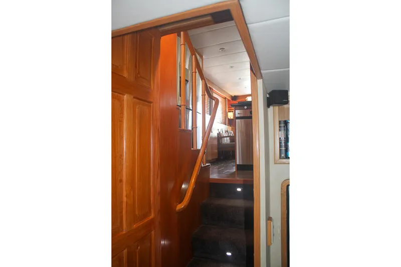 Slide: The Image of Interior staircase of 1999 Grand Alaskan Pilothouse yacht with wooden finish and modern design. - 150