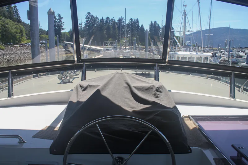Slide: The Image of Pilothouse view from 1999 Grand Alaskan yacht, overlooking marina with clear skies. - 156