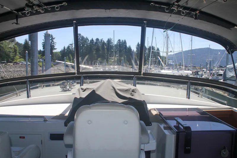 Slide: The Image of 1999 Grand Alaskan Pilothouse interior view with marina backdrop and clear skies. - 157