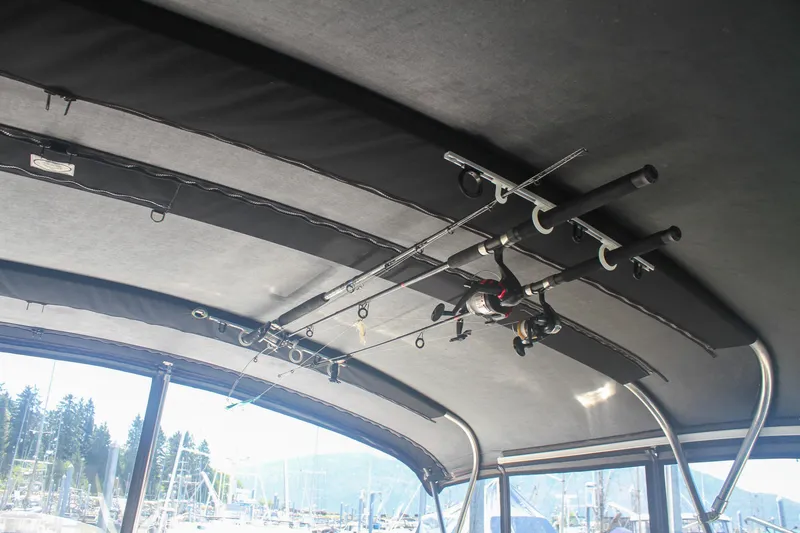 Slide: The Image of Interior view of 1999 Grand Alaskan Pilothouse with fishing rods stored on ceiling. - 159