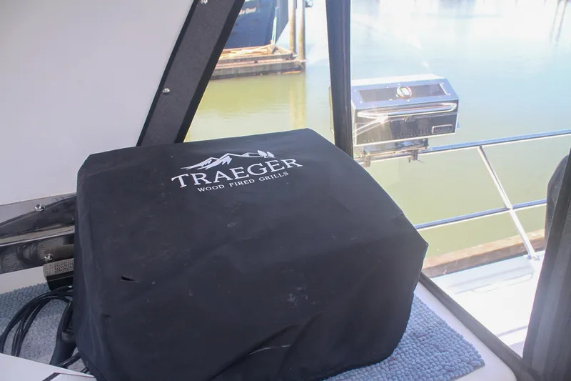 Slide: The Image of Traeger grill cover on 1999 Grand Alaskan Pilothouse yacht, overlooking marina. - 160