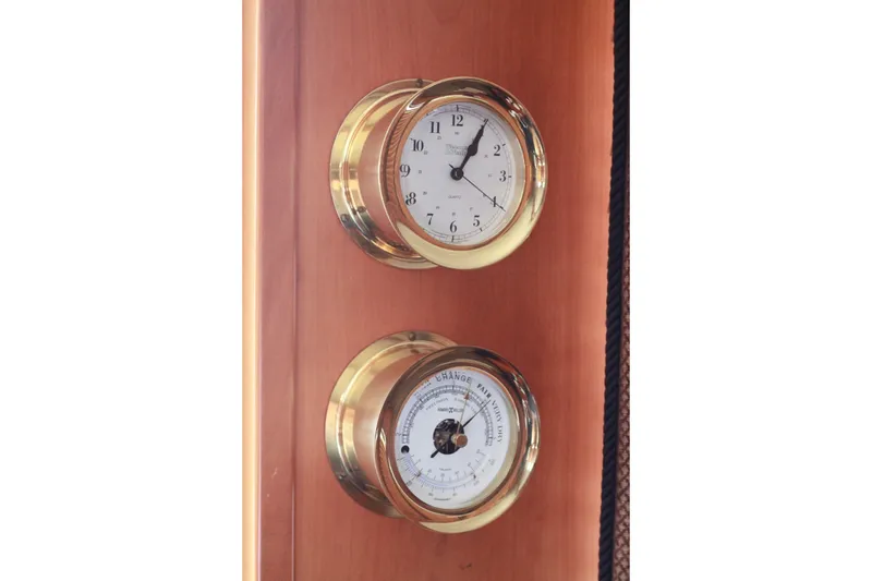Slide: The Image of Brass clock and barometer on 1999 Grand Alaskan Pilothouse yacht interior. - 162