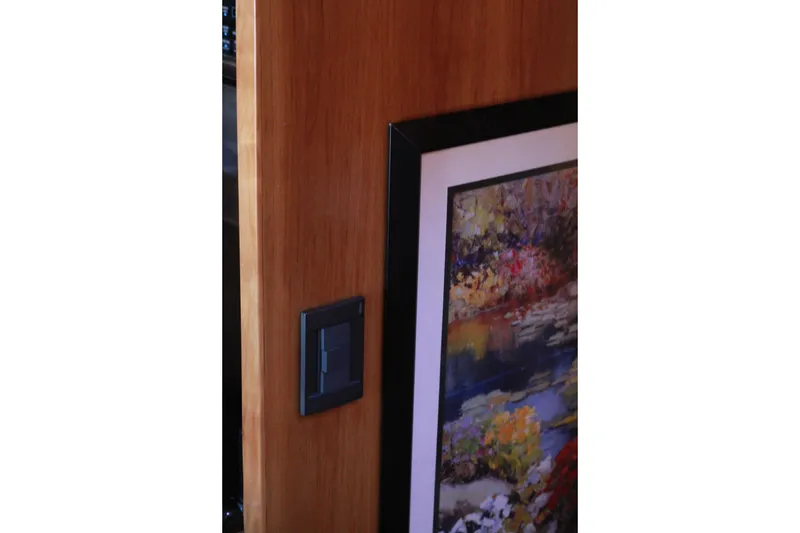Slide: The Image of Wooden interior with framed artwork and light switch on a 1999 Grand Alaskan Pilothouse. - 166