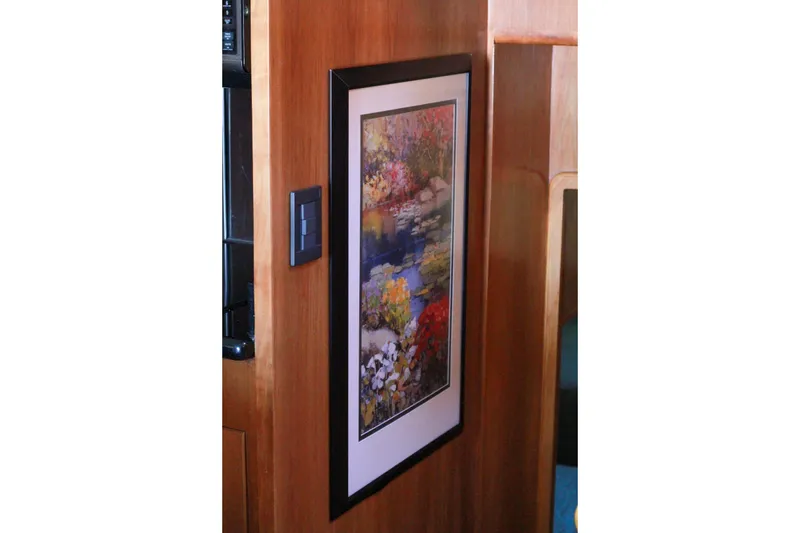 Slide: The Image of Framed floral artwork on 1999 Grand Alaskan Pilothouse wooden interior wall. - 167