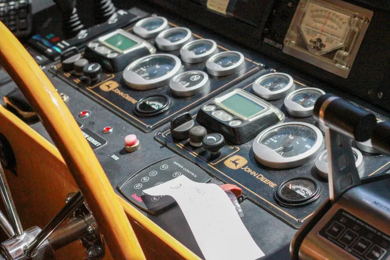 Slide: The Image of Control panel of a 1999 Grand Alaskan Pilothouse with gauges and steering wheel. - 170