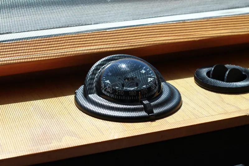 Slide: The Image of Compass on 1999 Grand Alaskan Pilothouse dashboard, illuminated by sunlight. - 177