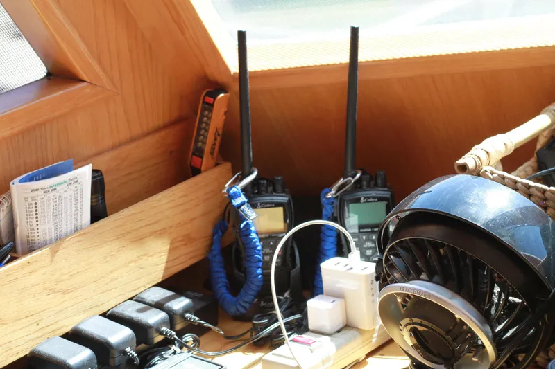 Slide: The Image of Pilothouse interior with communication devices and fan on a 1999 Grand Alaskan boat. - 178