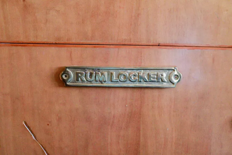 Slide: The Image of Rum locker on 1999 Grand Alaskan Pilothouse boat, wooden cabinet with brass label. - 186