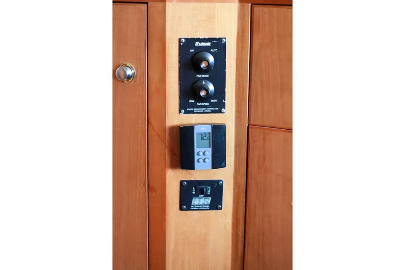 Slide: The Image of Control panel on 1999 Grand Alaskan Pilothouse yacht, featuring temperature and fan settings. - 187