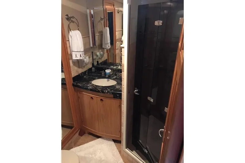 Slide: The Image of Bathroom interior of 1999 Grand Alaskan Pilothouse yacht with marble countertop and glass shower. - 20