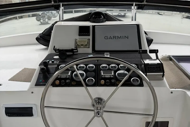 Slide: The Image of 1999 Grand Alaskan Pilothouse helm with Garmin navigation system and control panel. - 25