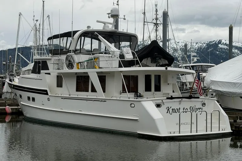 Slide: The Image of 1999 Grand Alaskan Pilothouse yacht "Knot to Worry" docked in a marina. - 28
