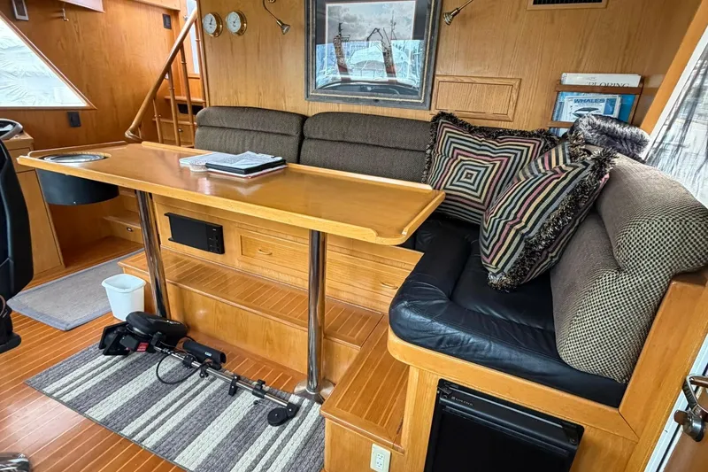 Slide: The Image of Cozy 1999 Grand Alaskan Pilothouse interior with wood accents and comfortable seating. - 3