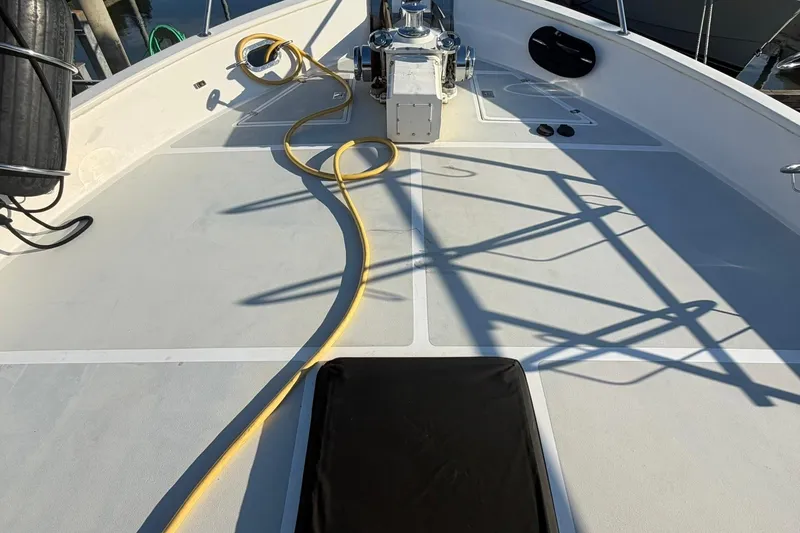Slide: The Image of Deck of 1999 Grand Alaskan Pilothouse with coiled yellow hose and winch. - 30