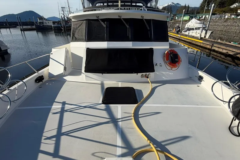 Slide: The Image of 1999 Grand Alaskan Pilothouse yacht deck with marina view and safety equipment. - 31