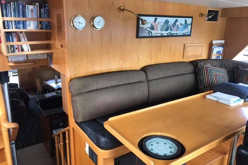 Slide: The Image of Interior of 1999 Grand Alaskan Pilothouse with cozy seating, wooden table, and nautical decor. - 4