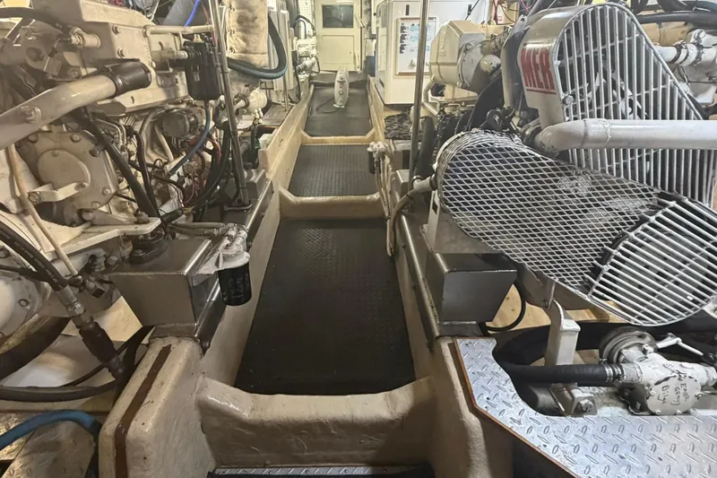 Slide: The Image of Engine room of a 1999 Grand Alaskan Pilothouse yacht, showcasing mechanical components. - 40
