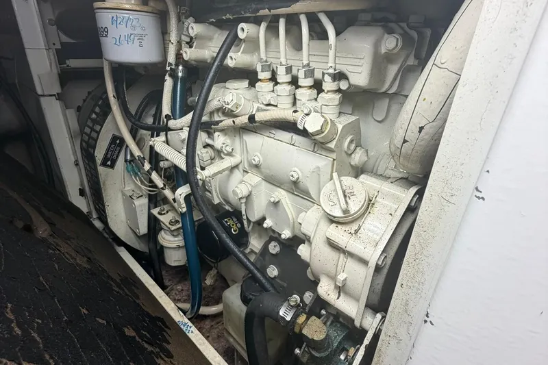 Slide: The Image of Engine compartment of a 1999 Grand Alaskan Pilothouse, showcasing mechanical components and wiring. - 41