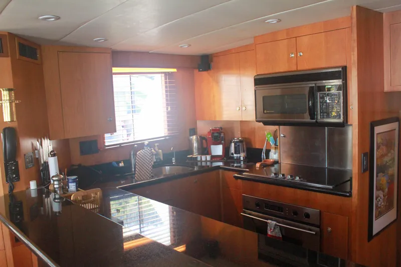 Slide: The Image of 1999 Grand Alaskan Pilothouse deck with covered equipment, docked in a marina. - 45