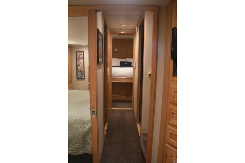 Slide: The Image of 1999 Grand Alaskan Pilothouse yacht docked, featuring "Knot to Worry" name and American flag. - 48