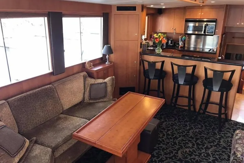 Slide: The Image of Luxurious 1999 Grand Alaskan Pilothouse interior with cozy seating and modern kitchen. - 6