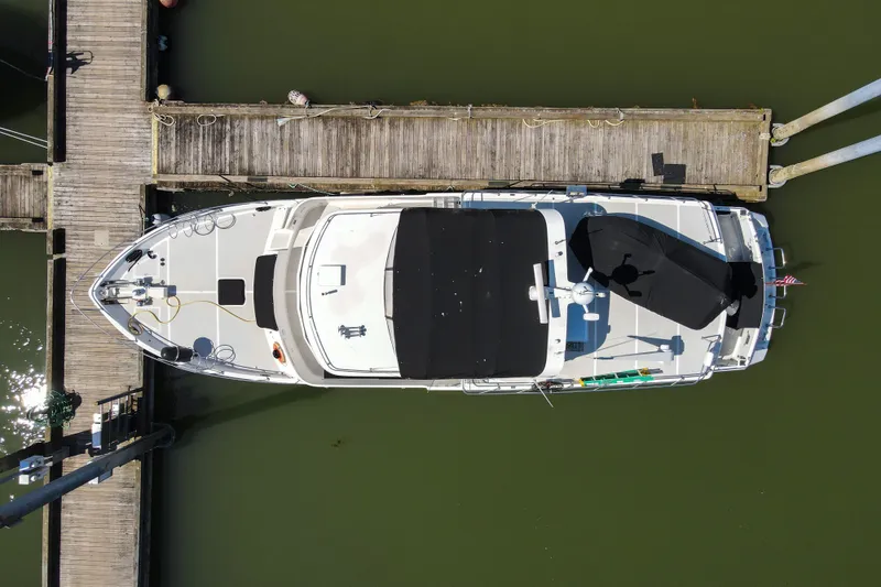 Slide: The Image of Overhead view of a 1999 Grand Alaskan Pilothouse yacht docked at a wooden pier. - 64