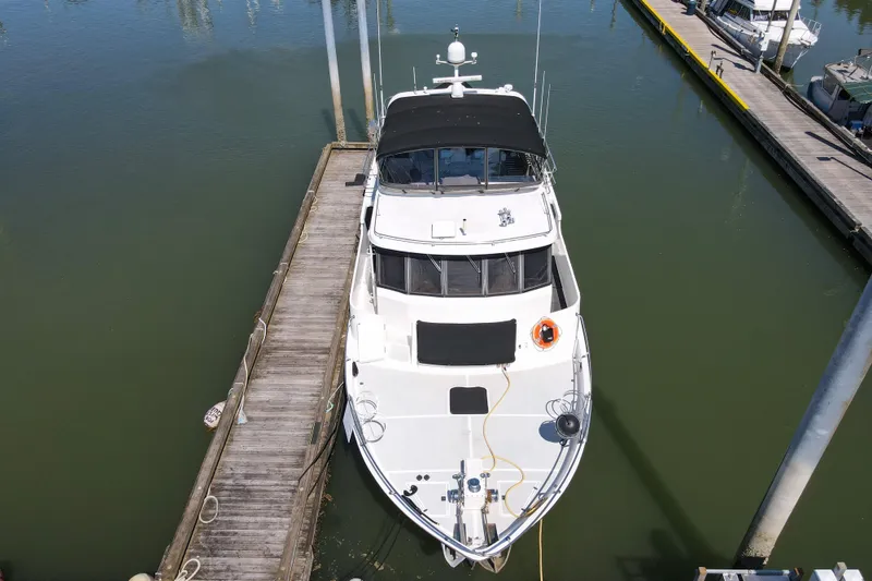 Slide: The Image of Overhead view of a 1999 Grand Alaskan Pilothouse yacht docked at a marina. - 65