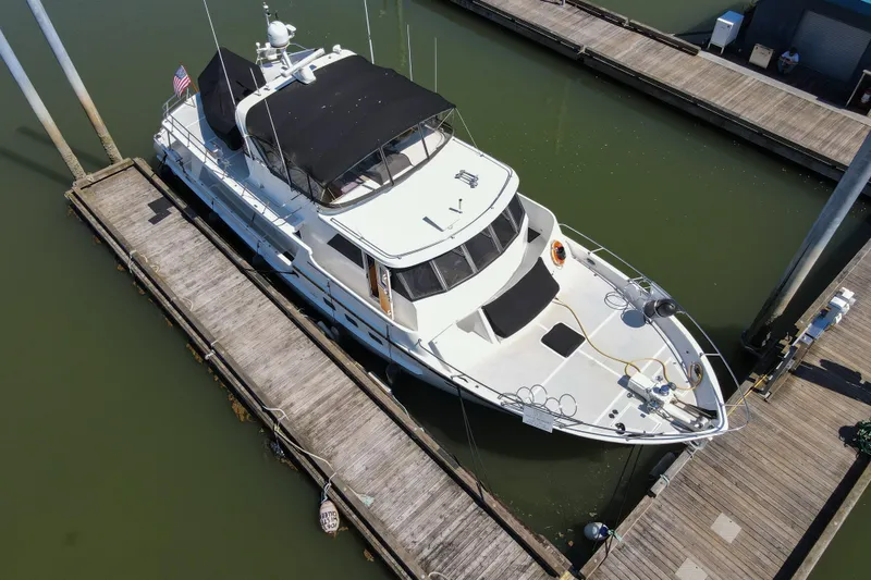 Slide: The Image of Aerial view of 1999 Grand Alaskan Pilothouse yacht docked at marina. - 69