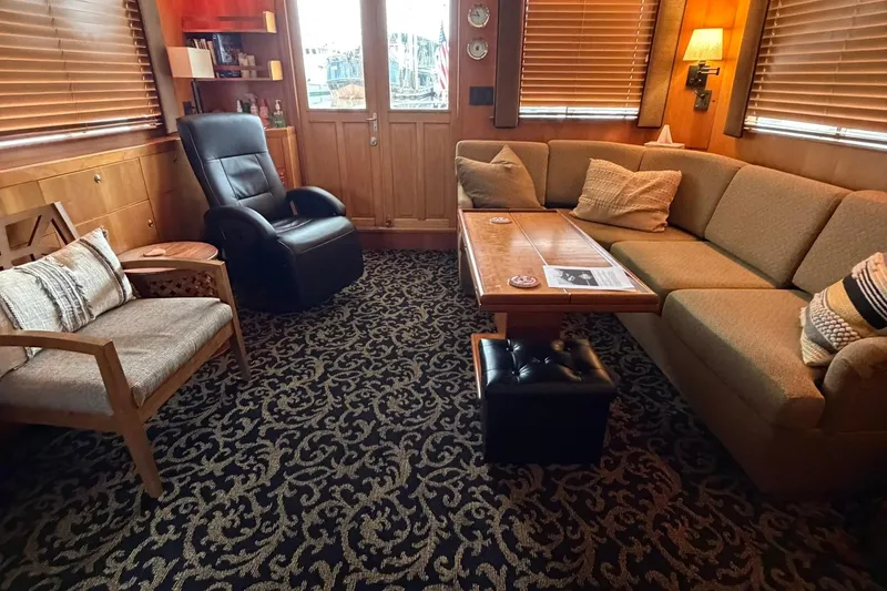 Slide: The Image of Cozy 1999 Grand Alaskan Pilothouse interior with plush seating and elegant decor. - 7