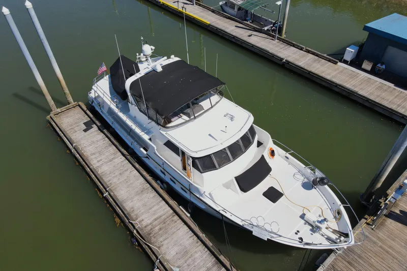 Slide: The Image of 1999 Grand Alaskan Pilothouse yacht docked at marina, aerial view. - 70